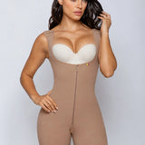 A woman modeling a beige full-body compression shapewear bodysuit with a front zipper, built-in underwire bra cups, and lace trim at the thighs, against a light gray studio background.