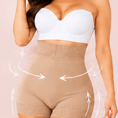A model wearing high-waisted beige shapewear shorts with a white bandeau top against a pale pink background. White graphic arrows and sparkles illustrate shaping support around the waist and hips.